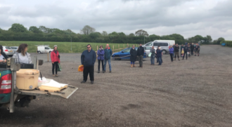 A socially distanced queue in the Strawberry Fields car park (Lifton)
